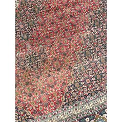 Perisian Bidjar crimson ground rug, within scalloped borders, central pole medallion, the field decorated all over with floral Herati motifs, guarded border decorated with repeating stylised plant motifs and trailing branch 