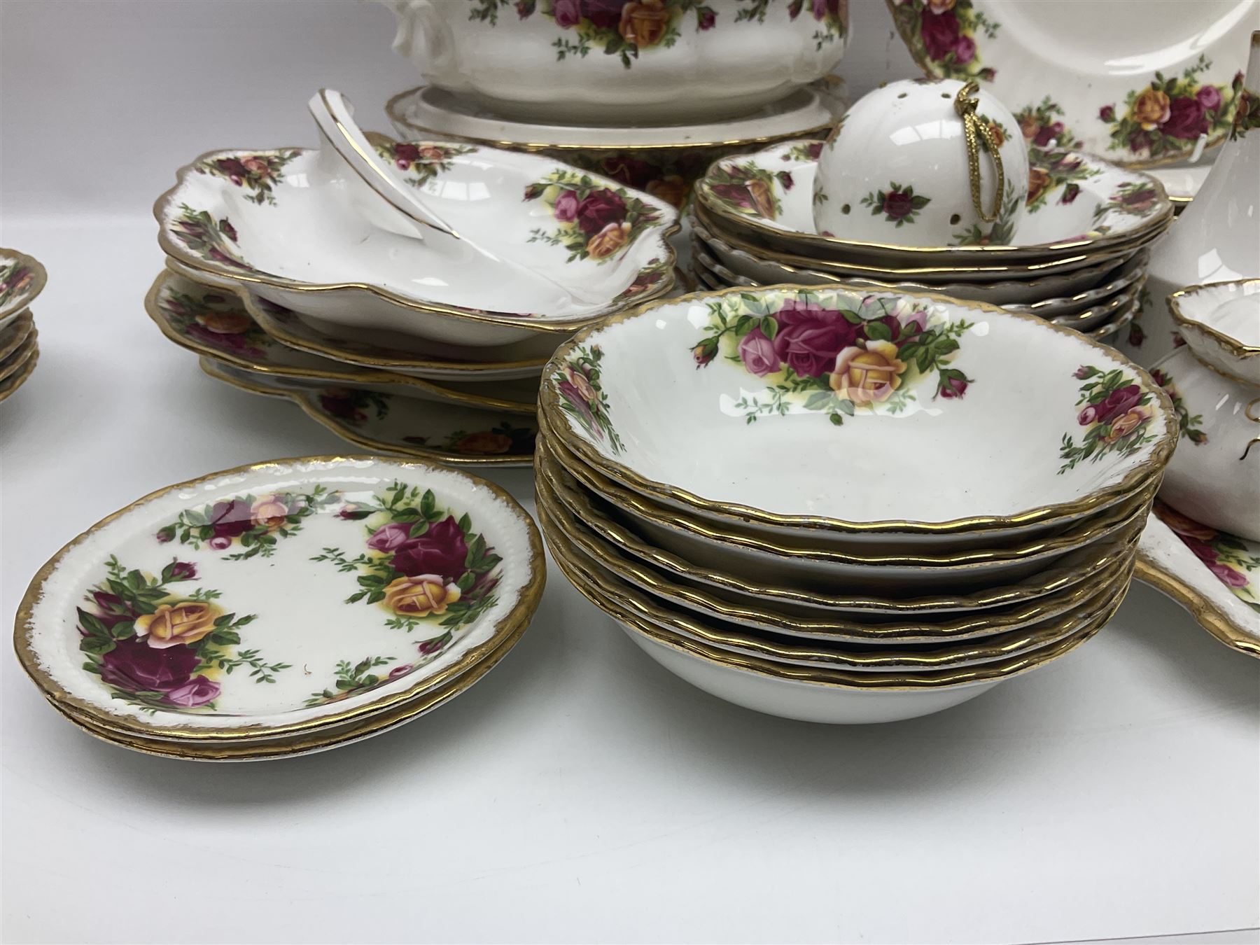 Royal Albert Old Country Roses pattern part tea and dinner service, to include two tureens, eight dinner plates, six side plates, twelve bowls, two mugs, seven teacups and saucers, milk jug,  twelve cake plates, six soup bowls and saucers, candlesticks, etc (95)