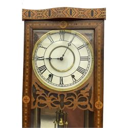 New Haven - American 19th century 8-day wall clock, inlaid parquetry case with fretwork, ring turned pilasters and finials, dial with Roman numerals, minute track and steel hands, with a visible faux mercury pendulum and mirror to the rear of the case, count wheel two train spring driven movement striking the hours on a bell.