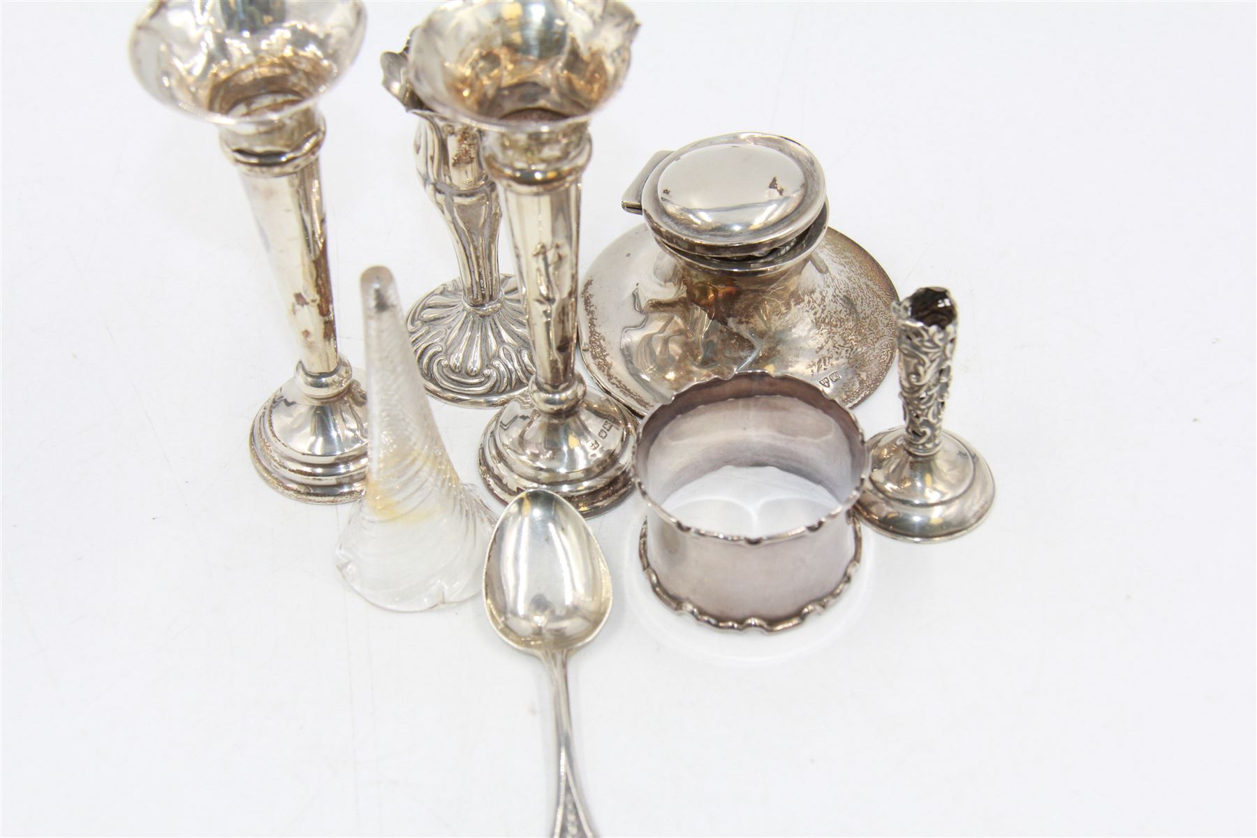 Group of silver to include two trumpet vases, inkwell, napkin ring, spoon, etc, all hallmarked