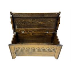 20th century oak coffer or blanket chest, rectangular hinged top over repeating Gothic arch carved front and shaped sides, constructed with pegged joints, on stile supports