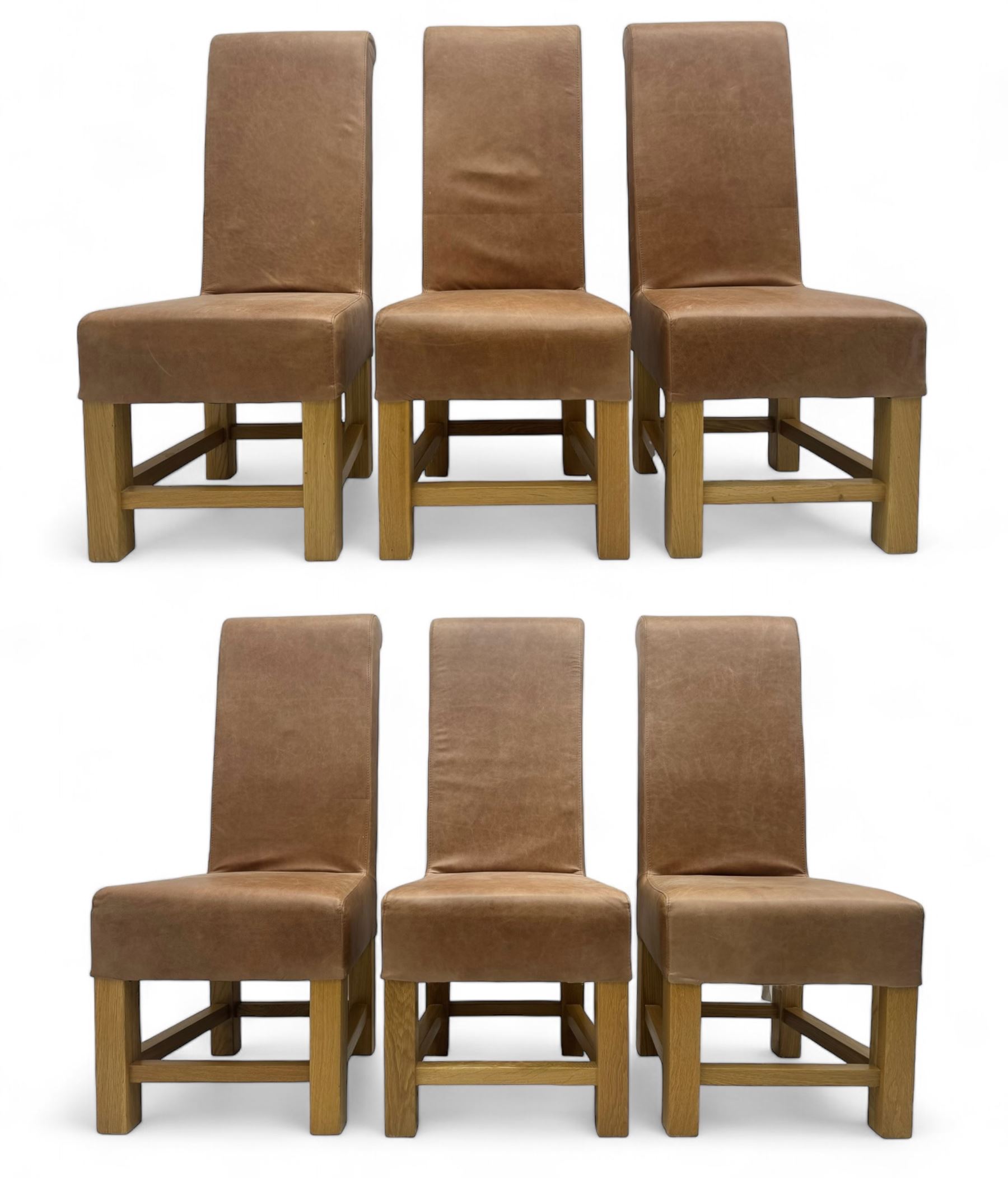 Set of six contemporary light oak dining chairs, each with high back and seat upholstered in pale tan leather, on square supports connected by H-stretcher