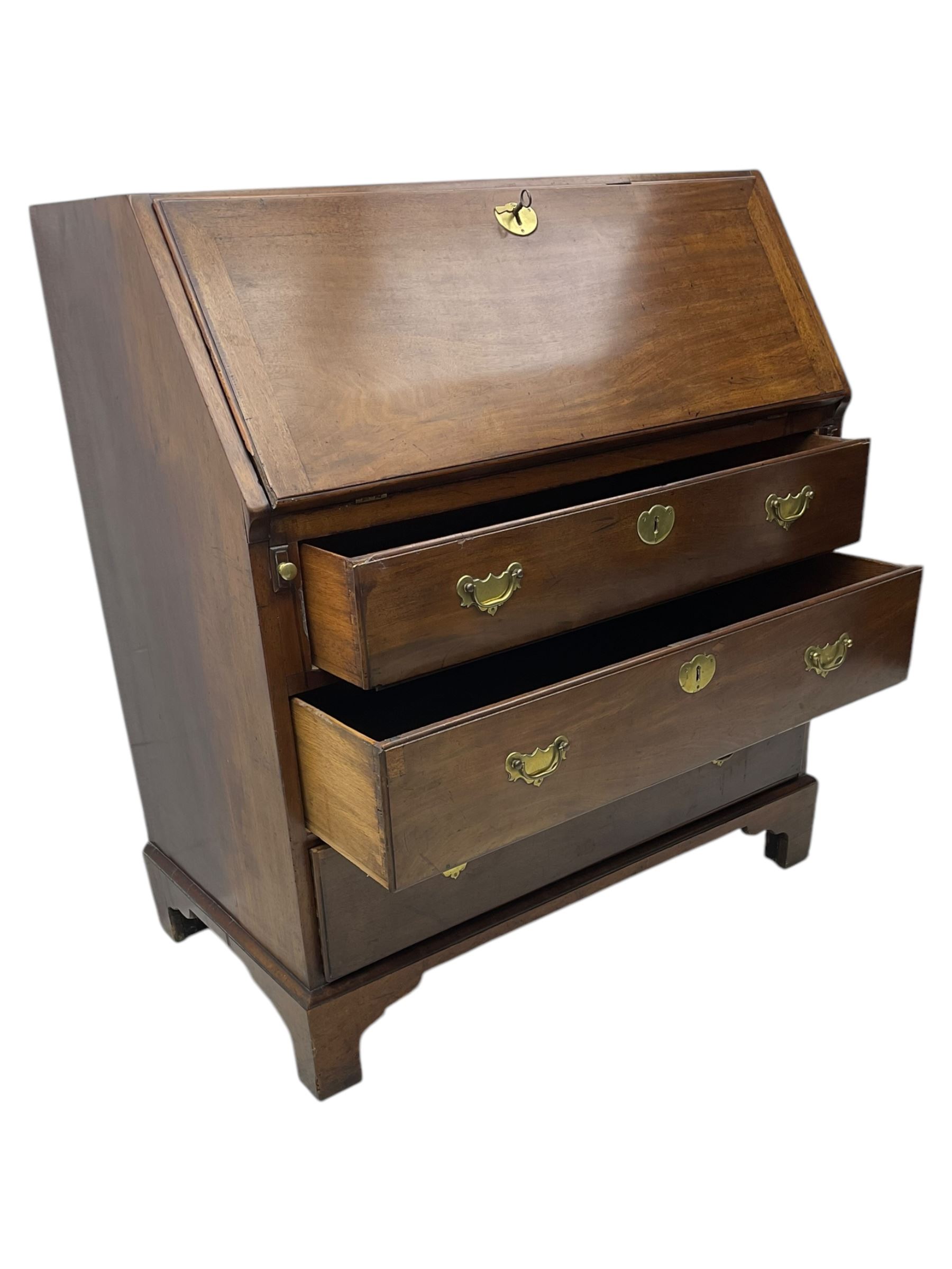 George III mahogany bureau, the fall front enclosing fitted interior, three graduating long drawers, on bracket feet