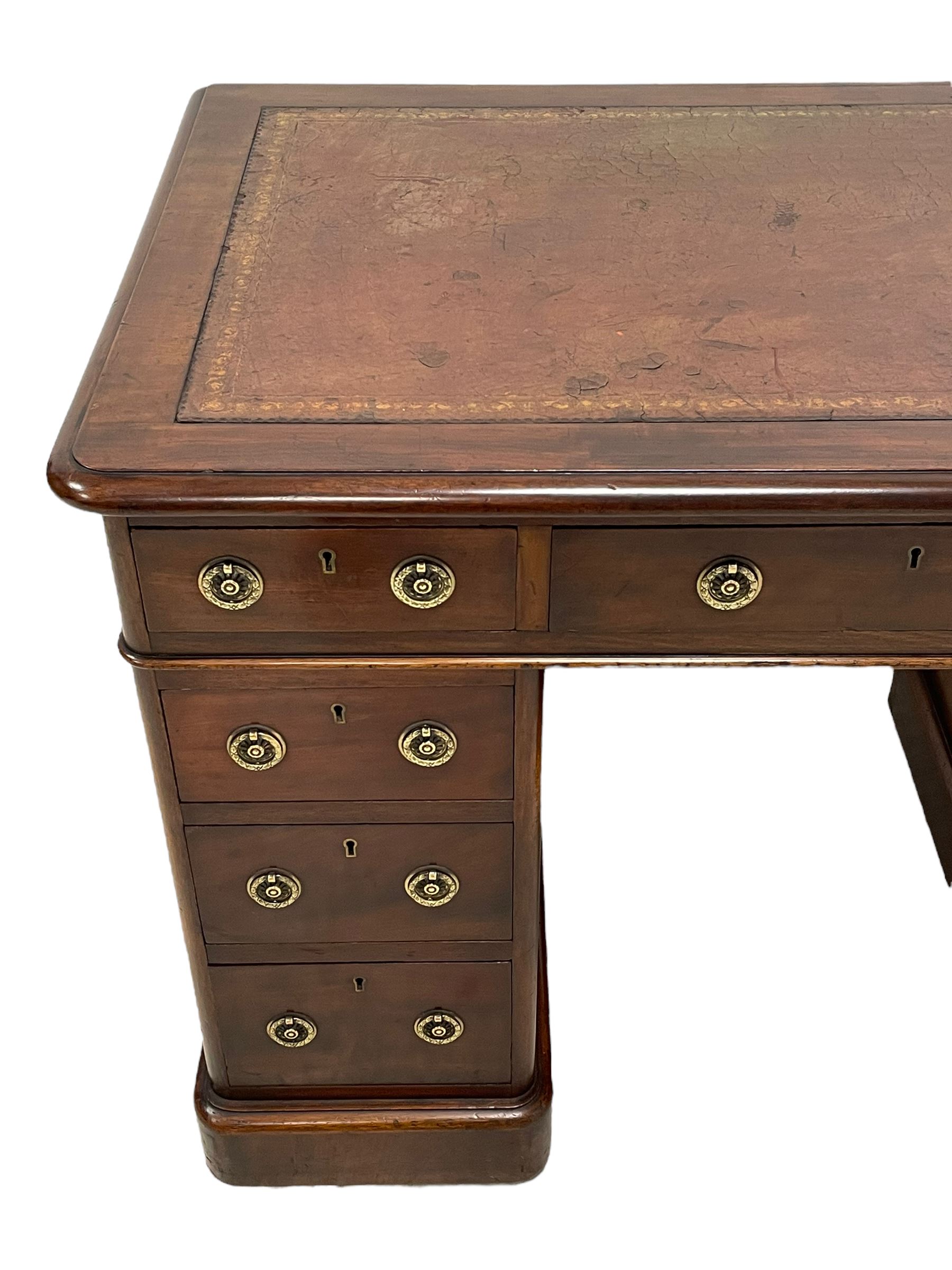 Victorian mahogany twin pedestal desk, moulded rectangular top with rounded corners and inset leather writing surface, fitted with nine drawers, on moulded plinth base