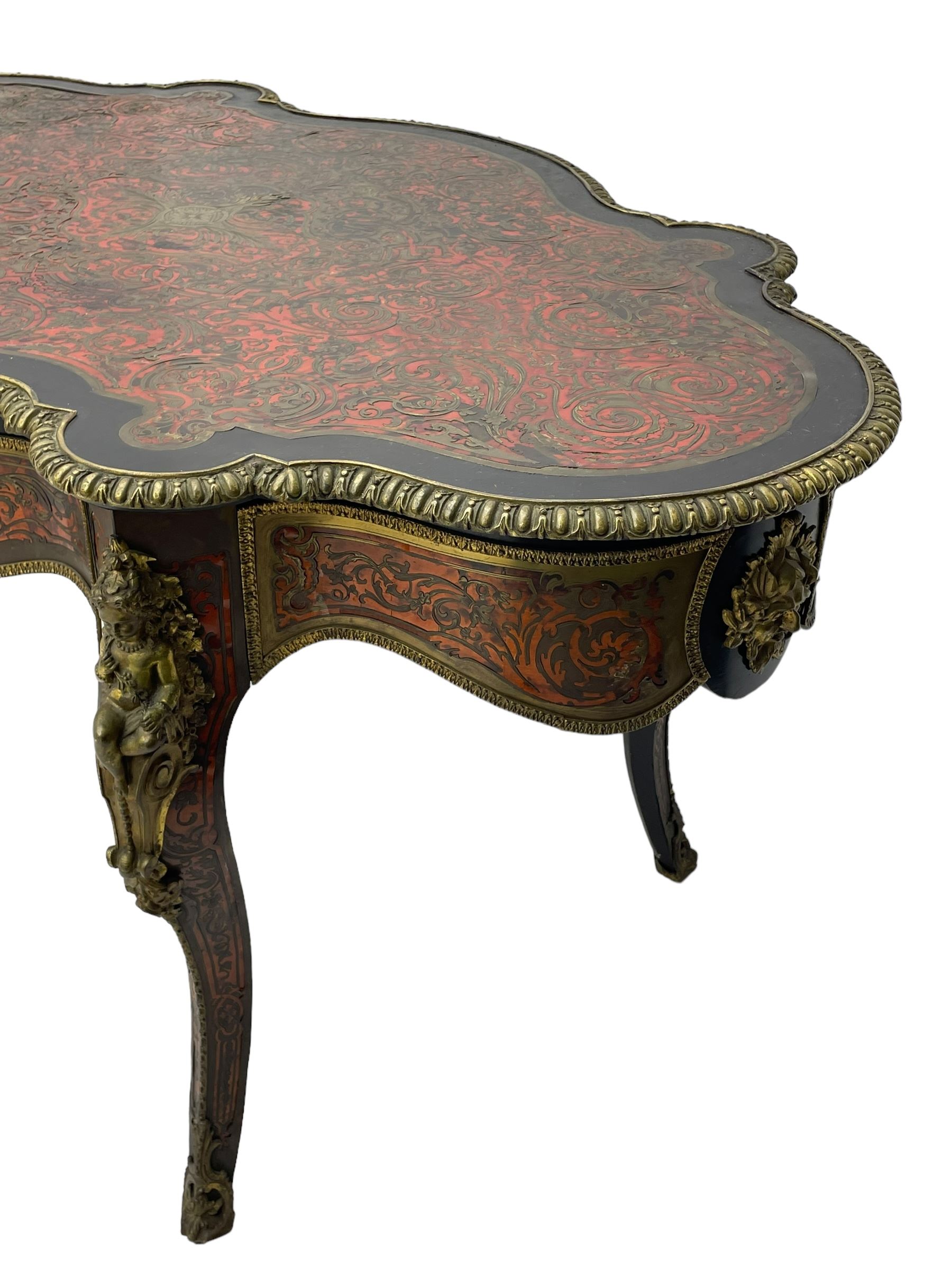 Victorian Louis XV design boulle work centre table, shaped form, decorated extensively with brass and red tortoise shell scroll work, central extending acanthus leaves surrounded by scrolling foliage, gardroon and floral cast brass edge, the frieze rails decorated with further boulle work and green man gilt metal cast masks, the cabriole supports mounted by seated putti mounts on S-scroll brackets surrounded by oak leaves and acorns, ornate scroll and floral cast terminal caps