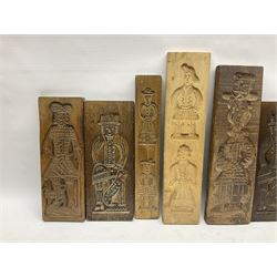 Collection of 20th century beech and other hardwood Dutch folk art Speculaasplank or biscuit moulds, most examples typically carved with figures in traditional dress, tallest H52cm