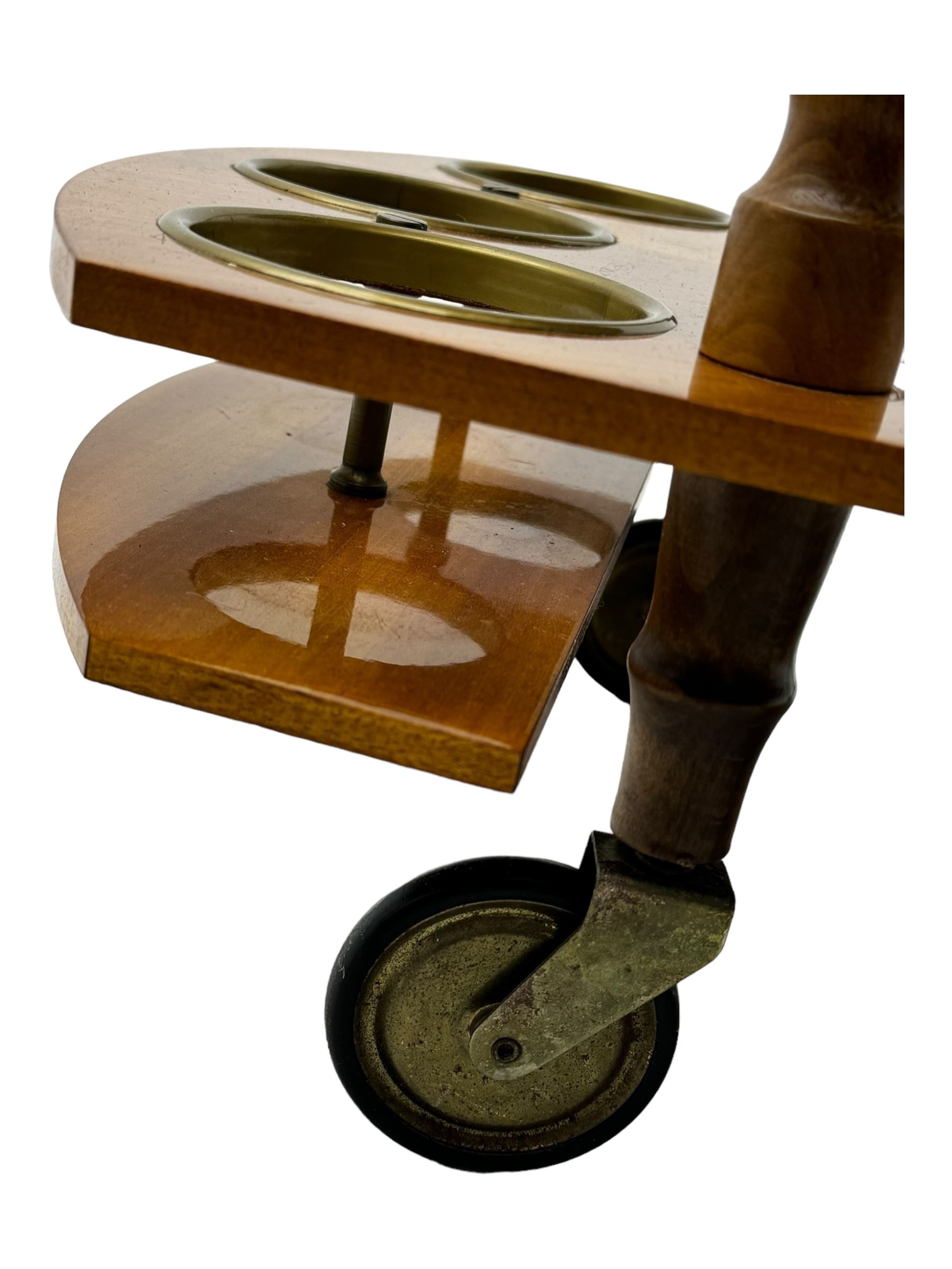 Mid 20th century walnut and satinwood drinks trolley, drop-leaf top with Italian marquetry, turned supports connecting lower shelf fitted with bottle holders and additional storage, on large brass-spoked wheels