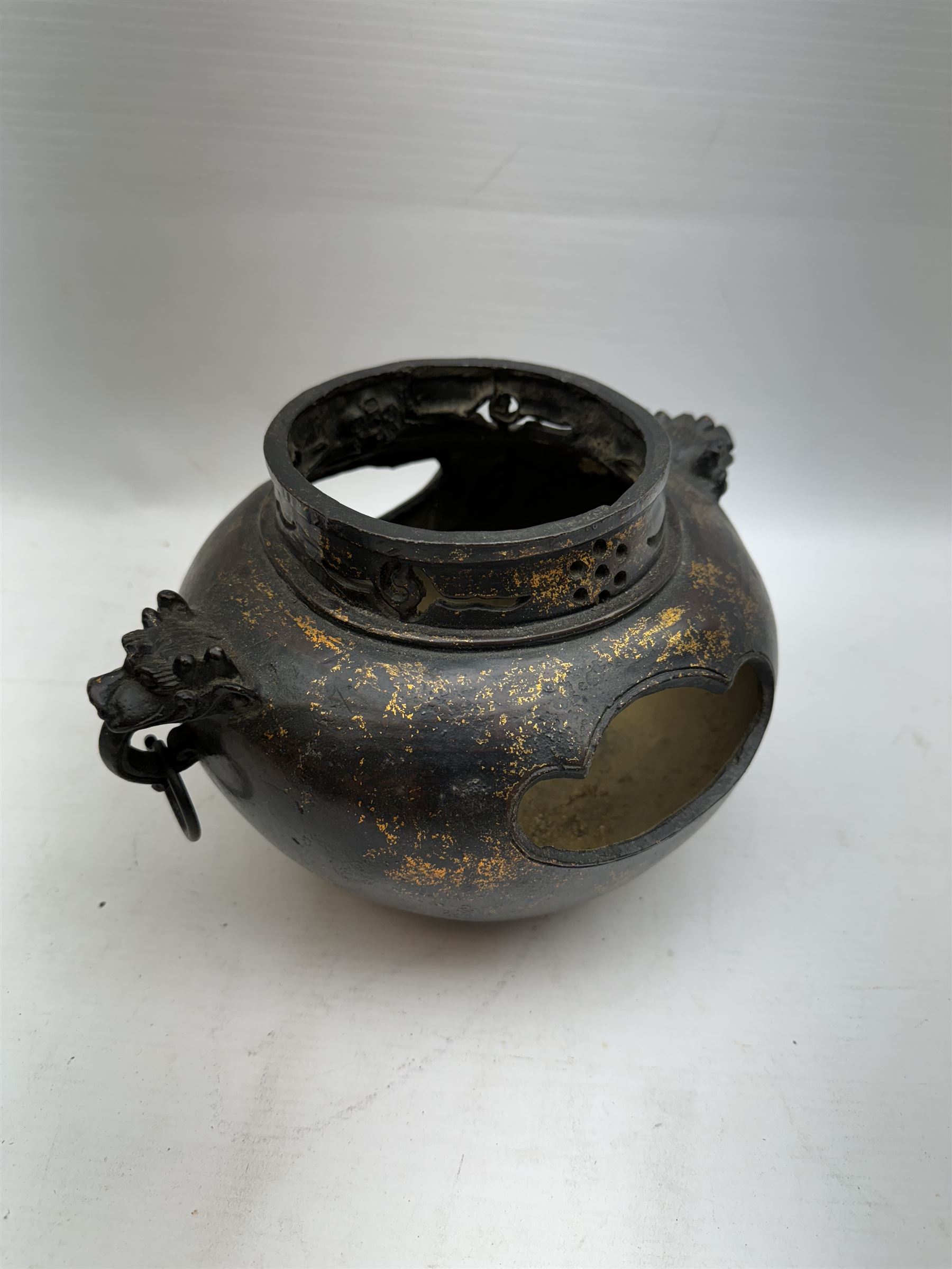 Chinese bronze incense burner, of squat form with mask and tongue handles, H15cm