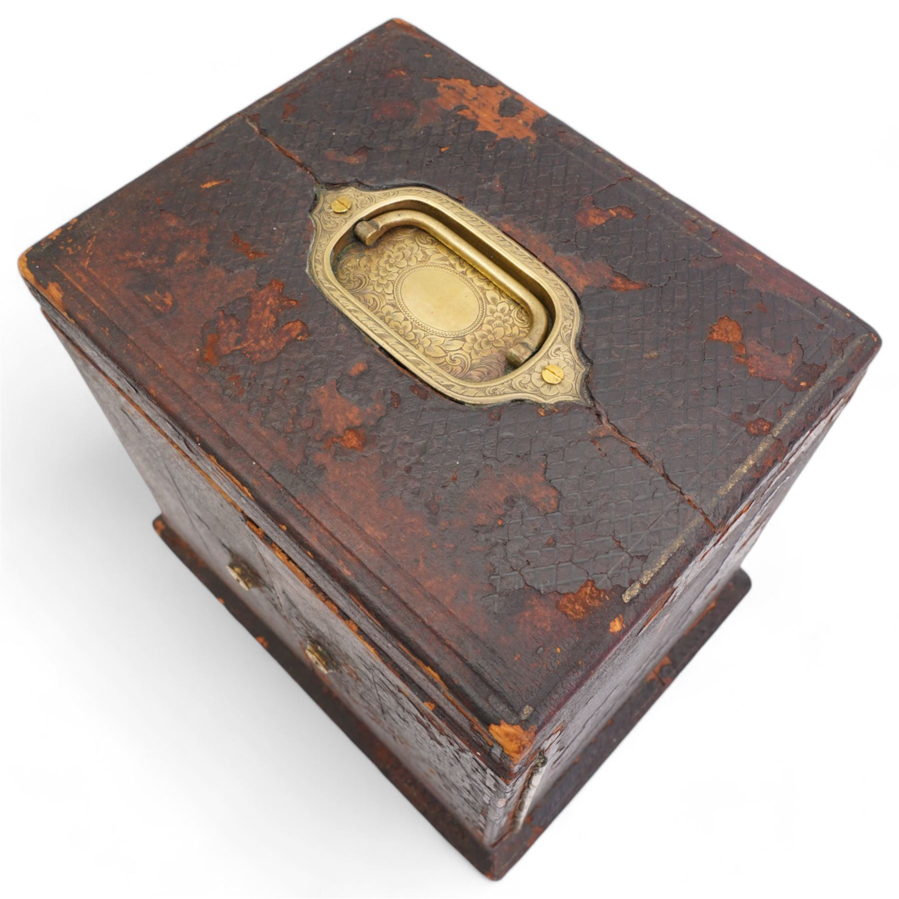 Victorian tooled leather jewellery casket, the cover with inset brass handle, two hinged doors open to reveal a top inset lined tray and central pocket watch, above two short and two long drawers, H22cm, W24.5cm, D19.5cm 