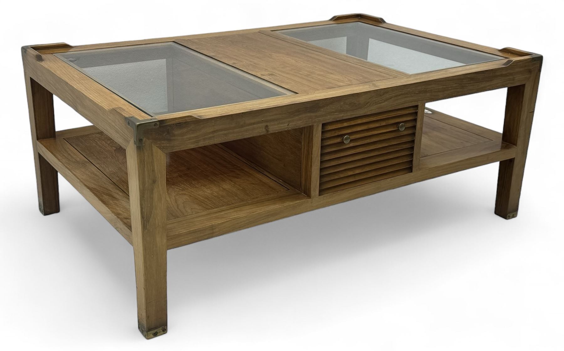 Starbay Tobago cherry wood coffee table, rectangular top with two inset glass panels, central drawer with louvred front and brass handles, flanked by open shelving, raised on square supports with metal corner brackets