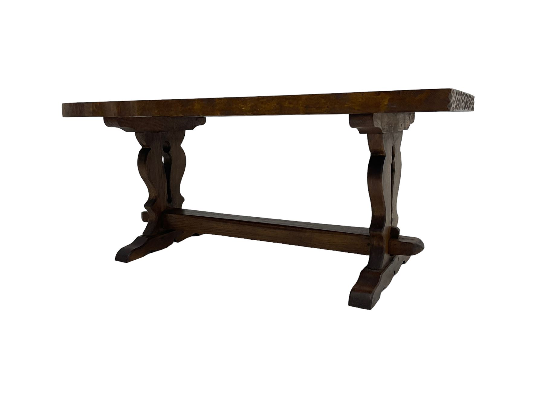 Solid oak coffee table, rectangular waved cut top with tooled ends, on shaped and pierced end supports joined by pegged stretcher 