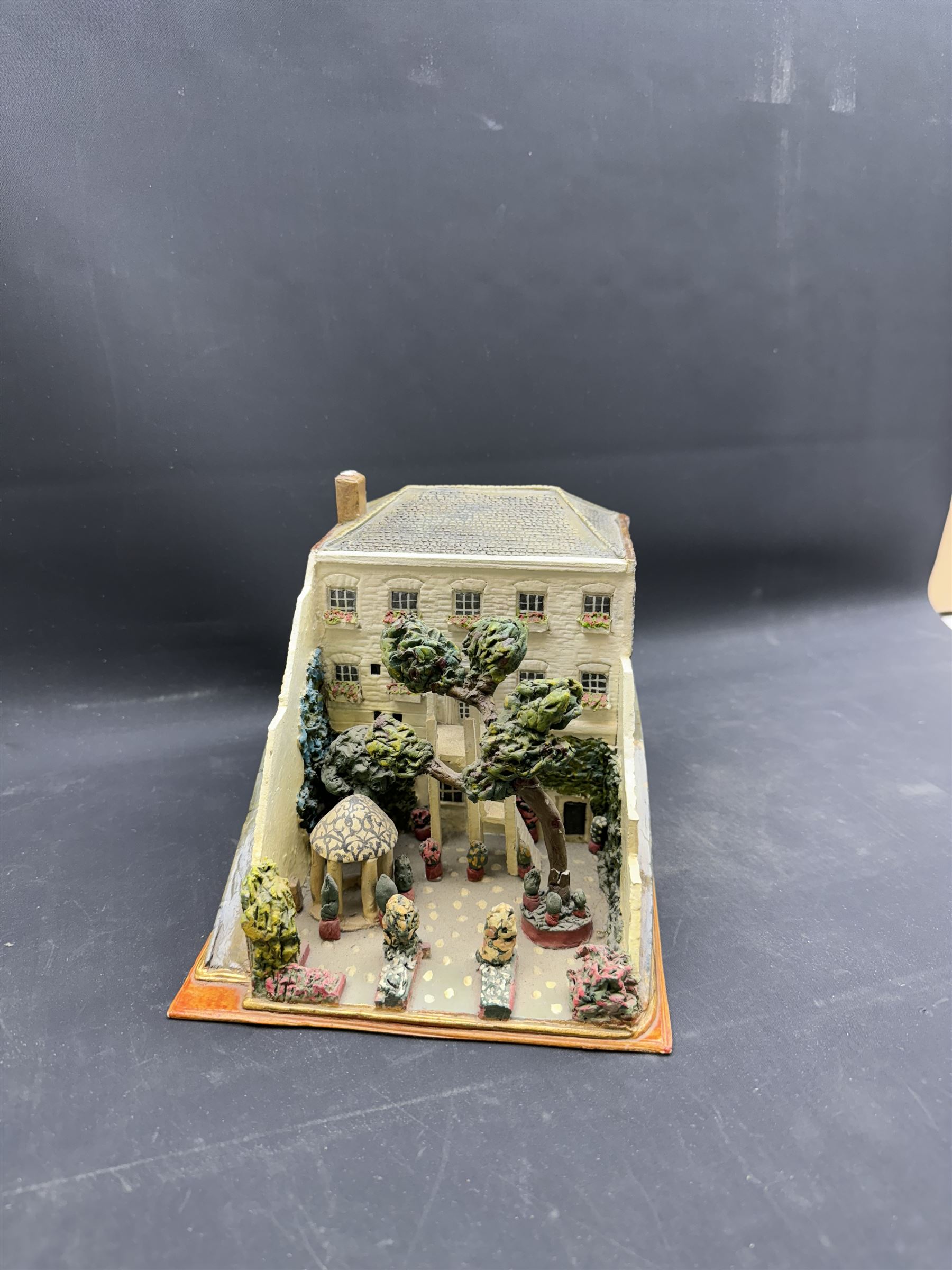 Mixed medium sculpture of house and garden, with makers mark beneath, H15cm