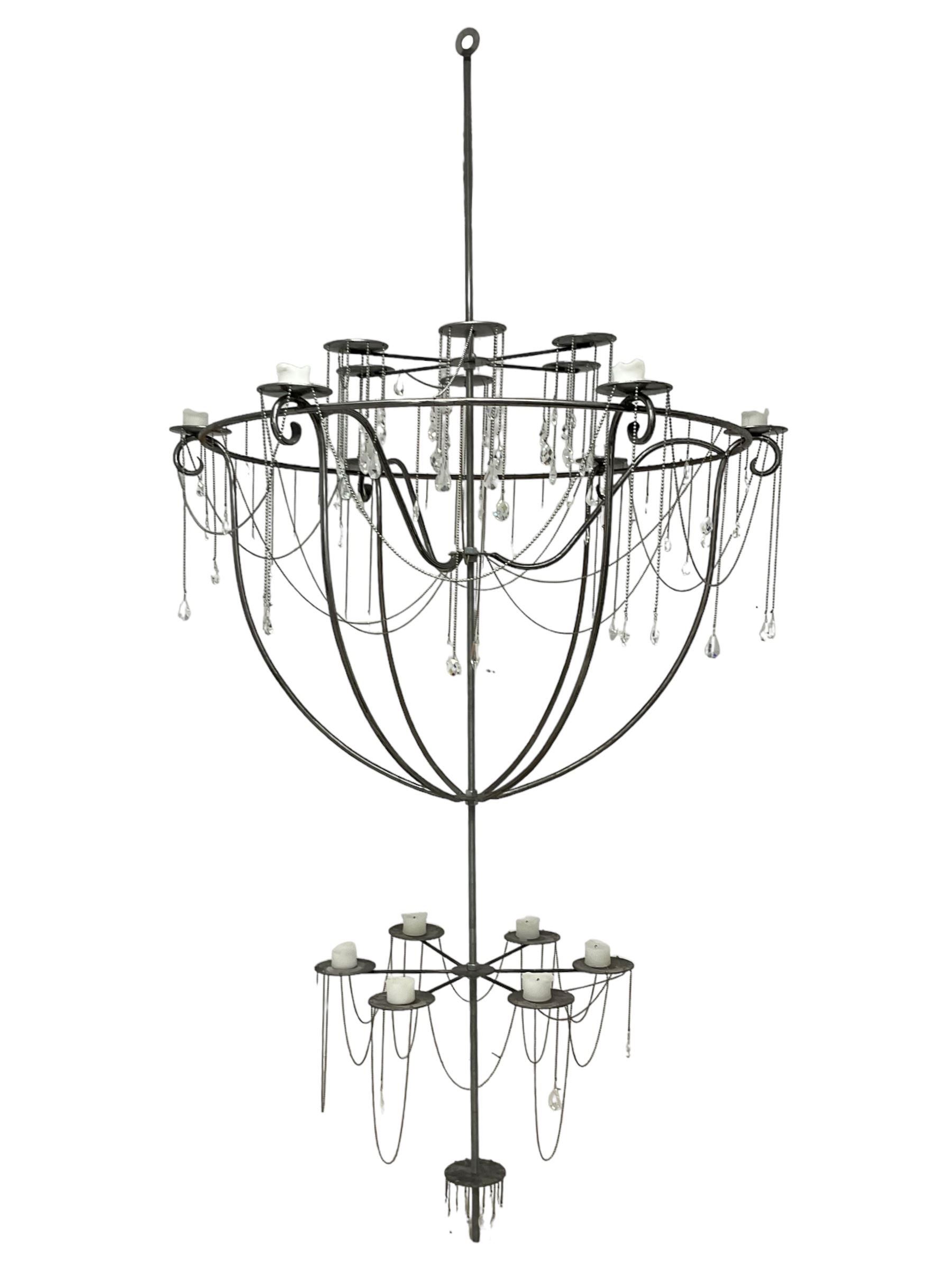 Large bespoke wrought iron cage candle chandelier, the top tier with six extending branches over bell-shape cage with scrolled supports and six branches, six branch lower tier; together with ceiling winch 