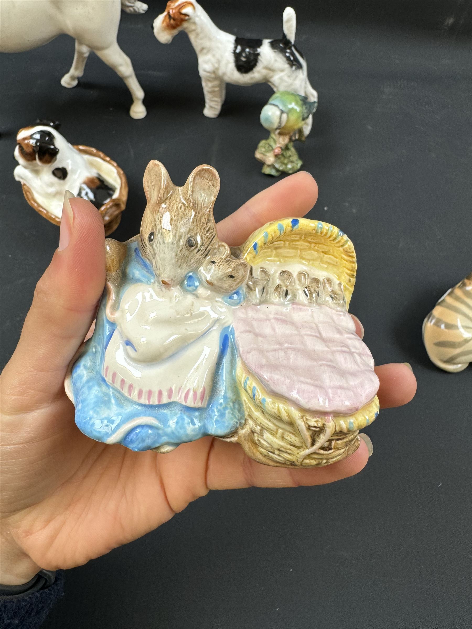 Two Royal Doulton figures of puppies in baskets, together with Beswick horse and other animal figures