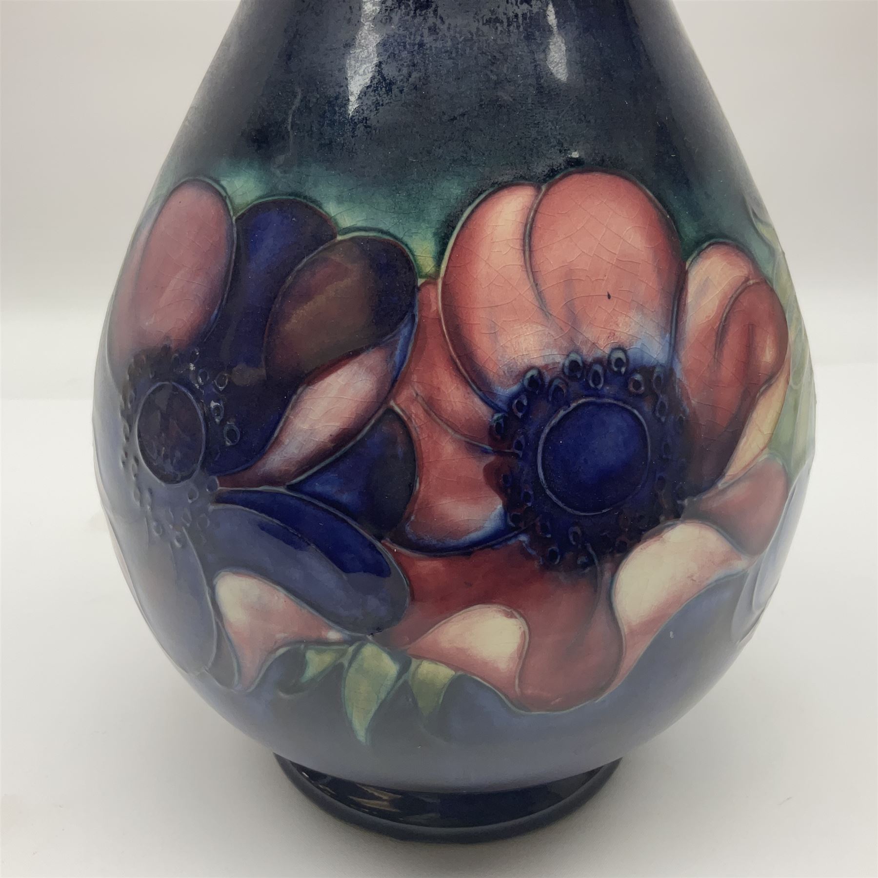 Moorcroft Anemone pattern vase of baluster form, upon a blue ground, with painted and impressed marks beneath, H24cm