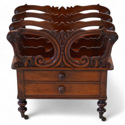 Victorian mahogany Canterbury, three divisions, carved with scrolls and curled leaf motifs, fitted with two drawers, on turned feet with brass cups and castors 