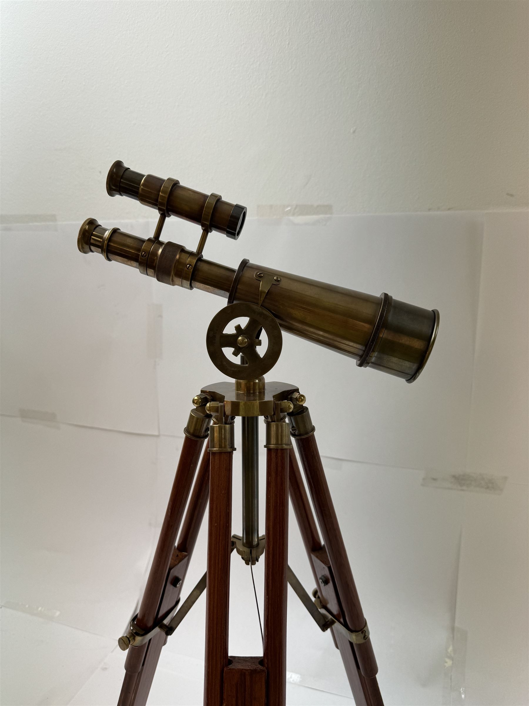 Brass telescope upon a wooden adjustable tripod, H55cm 