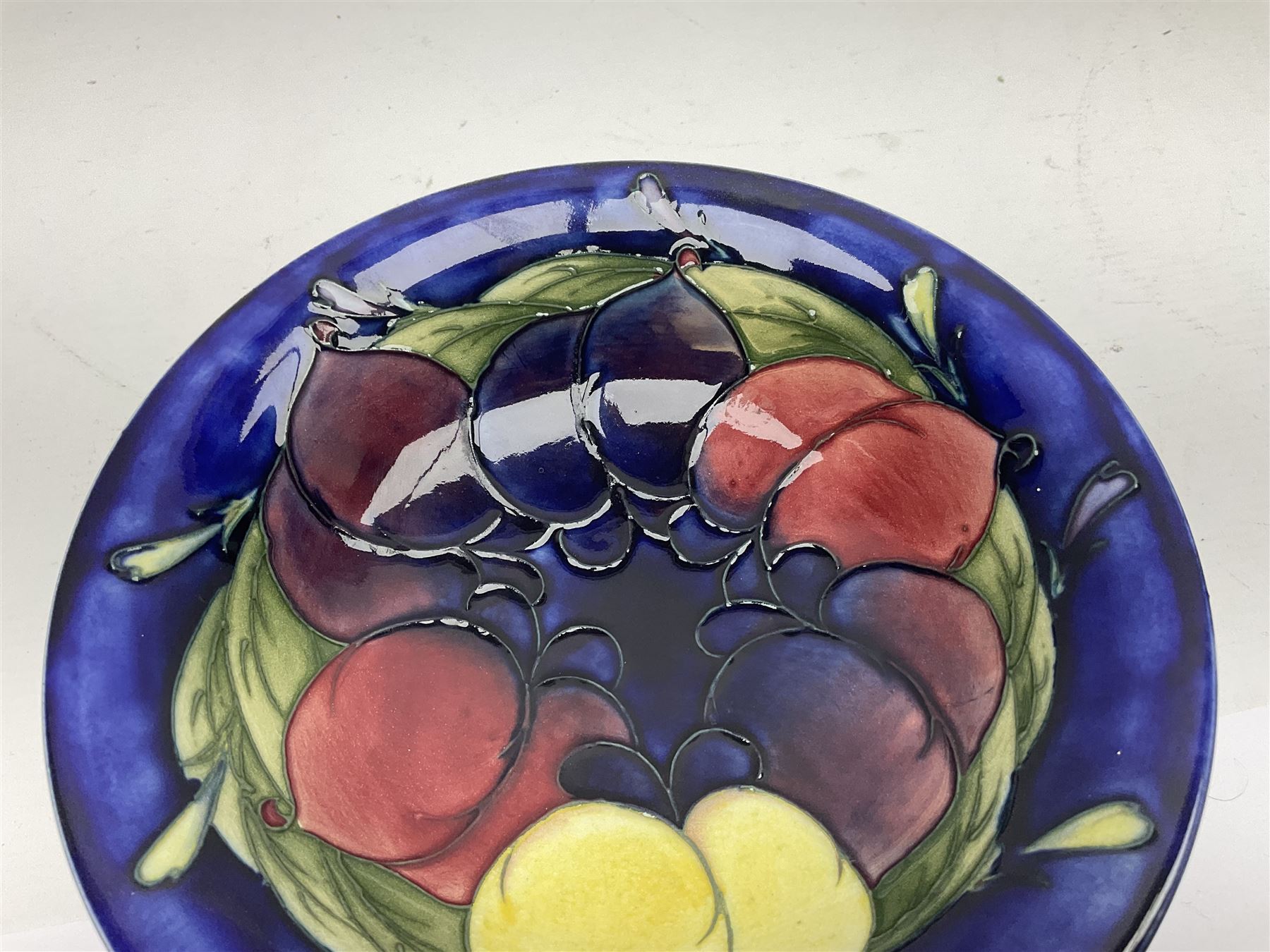 Moorcroft small pedestal dish decorated in the Wisteria pattern against a dark blue ground raised to a Tudric pewter stand, impressed beneath Tudric, Moorcroft, H9cm