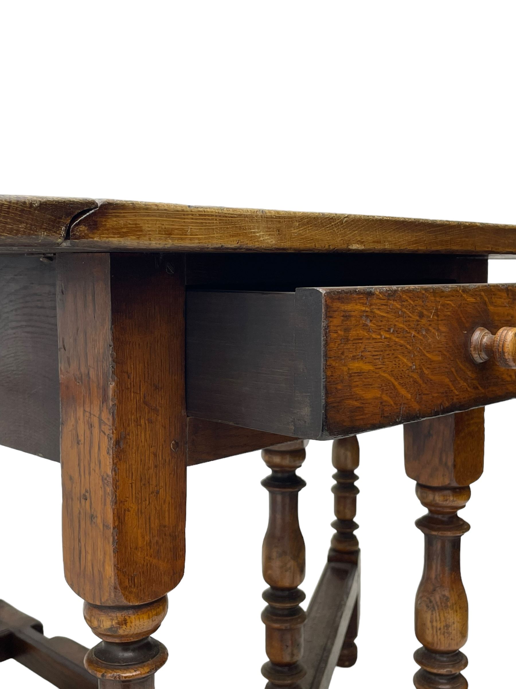 18th century oak dining table, oval drop-leaf top on gate-leg action base, turned supports united by turned stretchers, fitted with single end drawer