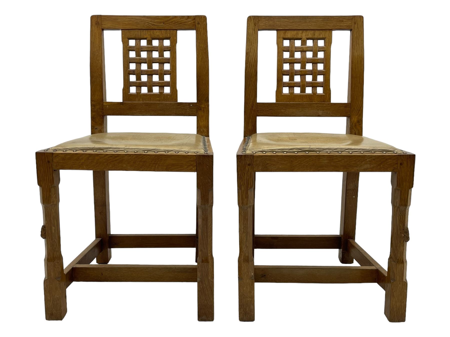 Rabbitman - set of six (5+1) oak dining chairs, pierced and carved lattice back, leather upholstered seat with stud band, on octagonal supports united by stretchers, carved with rabbit signature, by Peter Heap of Wetwang 