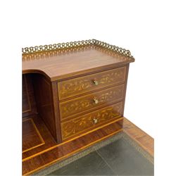 Edwardian inlaid mahogany writing desk, raised galleried back over inlaid central urn with scrolling leafy branches and six small drawers, satinwood banded rectangular moulded top with tooled leather inset, fitted with five drawers, the drawer facias inlaid with scrolling foliage and satinwood banding, square tapering supports inlaid with trailing bell flowers, on brass and ceramic castors 