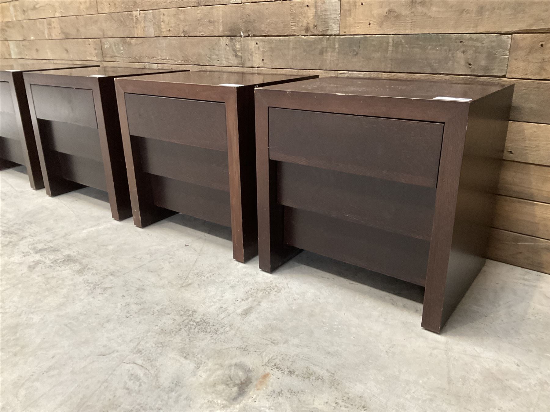 Four rosewood bedside chests, fitted with three stepped soft-close drawers