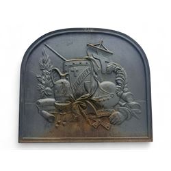 French cast iron fireback, arched form with relief of medieval armour and heraldic symbols, including a shield with a cross and a plumed helmet