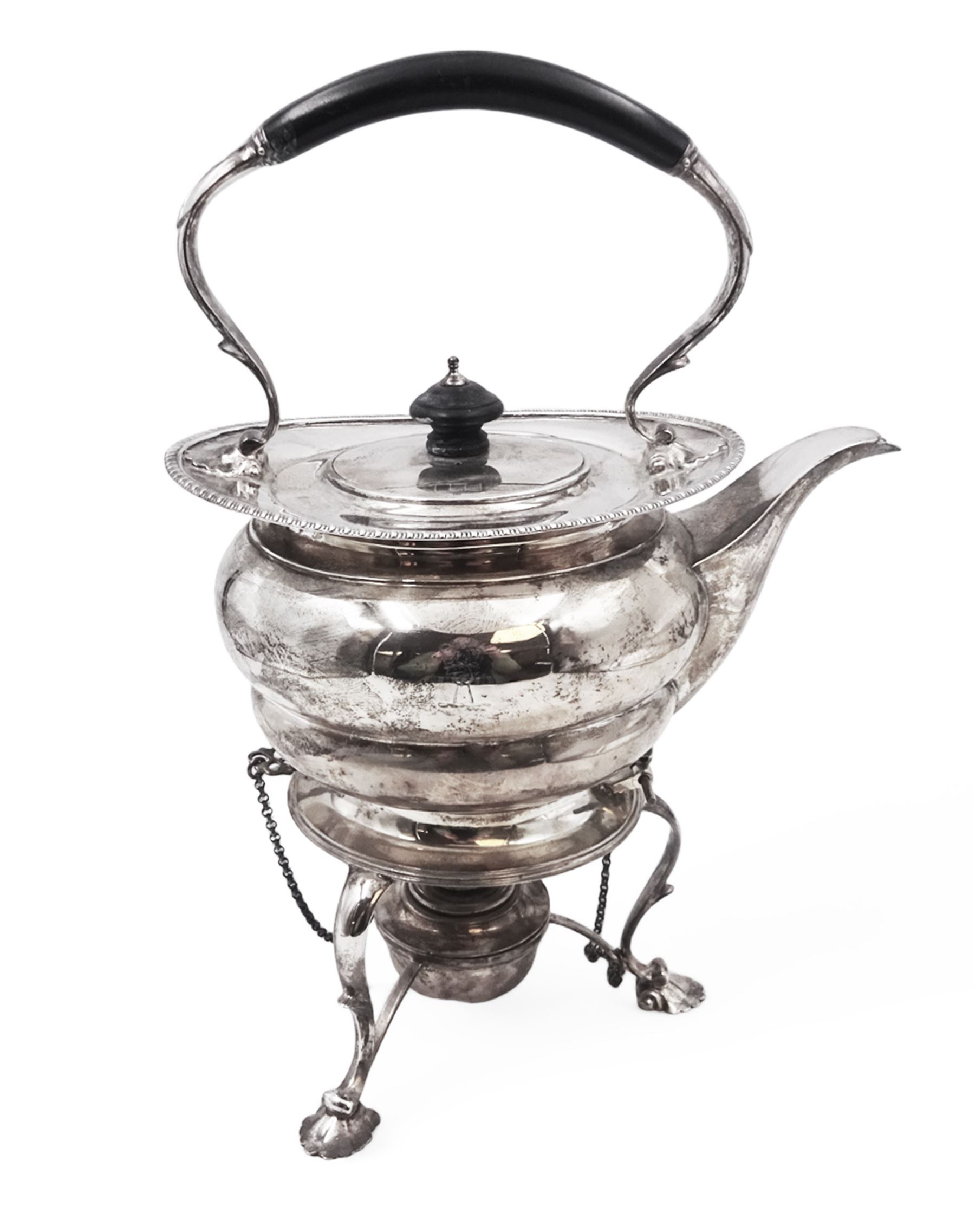 Early 20th century silver spirit kettle and burner, of oval form, with oblique gadrooned rim, engraved crest and ebonised handle and finial, the stand upon three scrolling pad feet, hallmarked Goldsmiths Silversmiths Company, London 1913, total H31cm