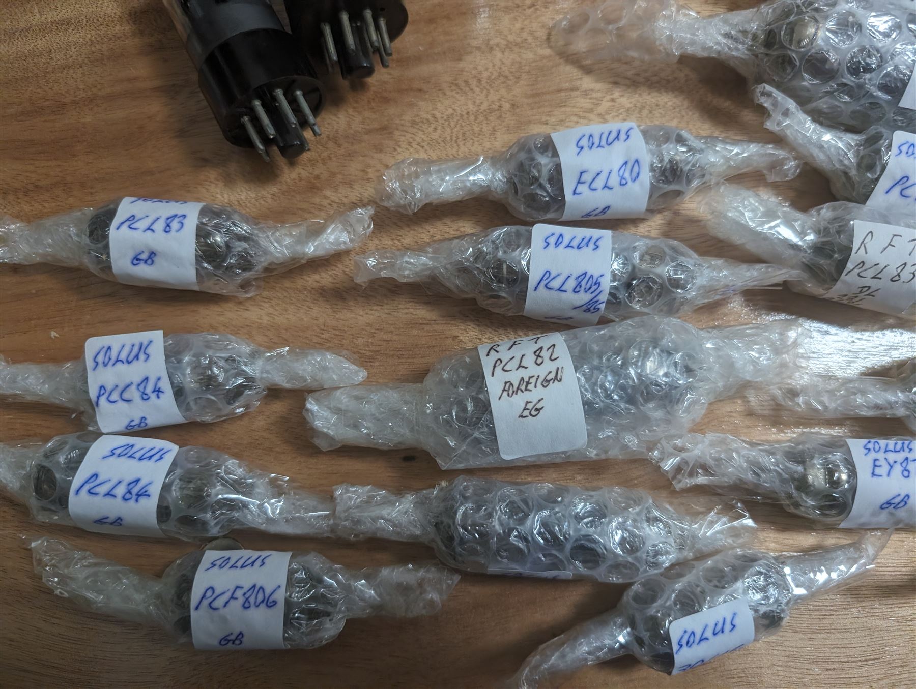 Large collection of thermionic valves/vacuum tubes, by various makers, mostly wrapped in bubble wrap with identifying stickers, together with a collection of empty valve boxes including Pinnacle, Mullard etc