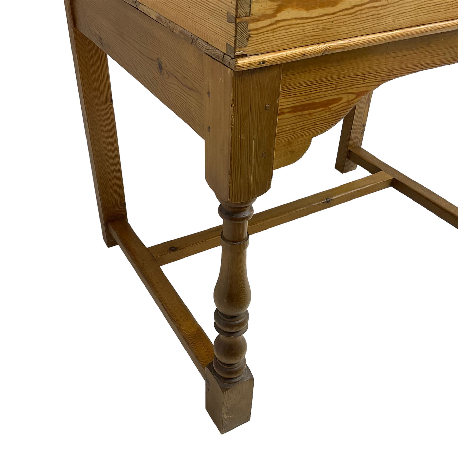 Early 20th century pitch pine clerk’s desk, stripped mahogany sloped hinged top, raised on turned supports