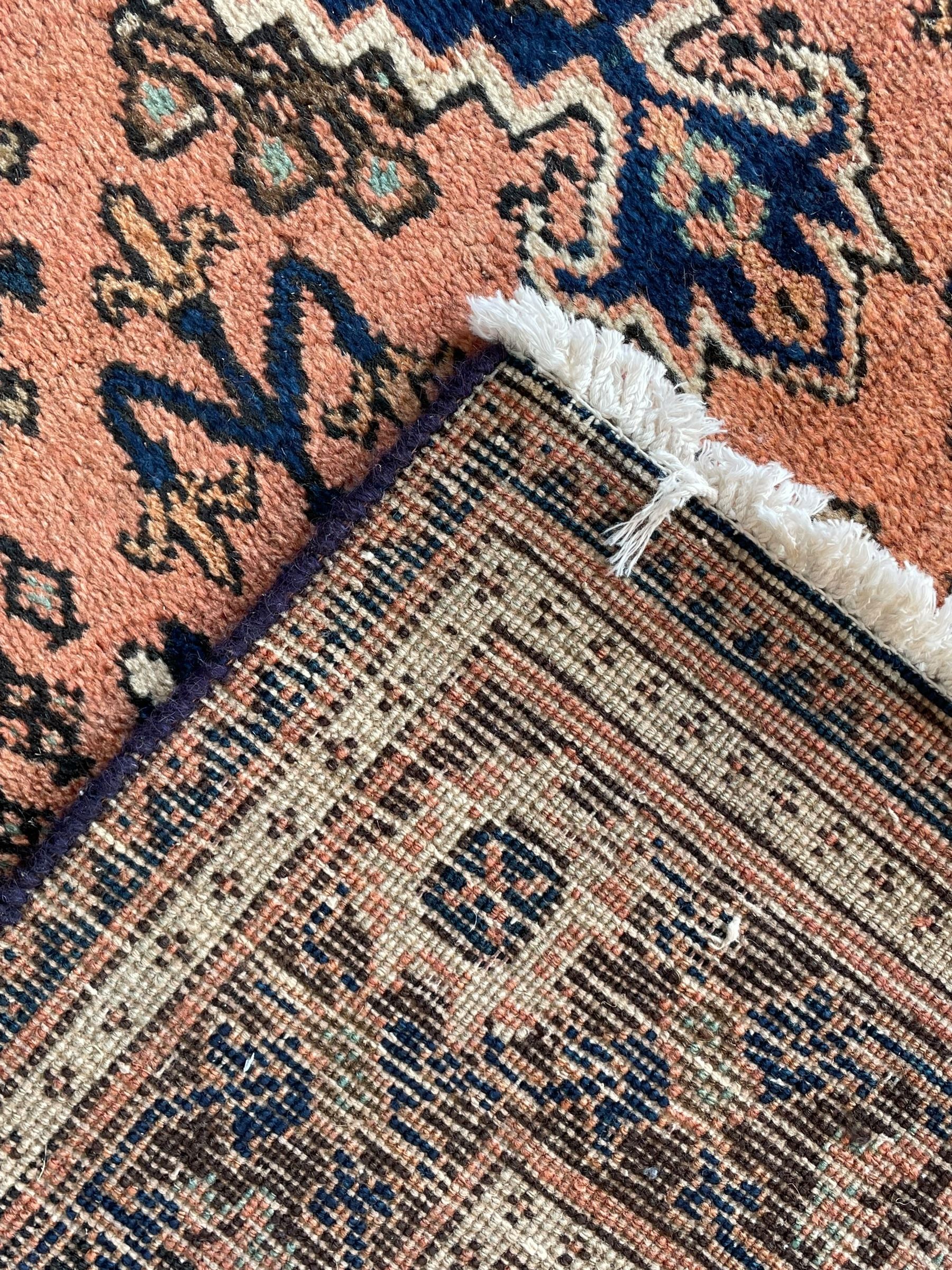 Persian Joshaghan peach and blue ground rug, central stepped lozenge medallion surrounded by bunches of floral motifs, repeating border decorated with stylised plant motifs, within multiple guard stripes