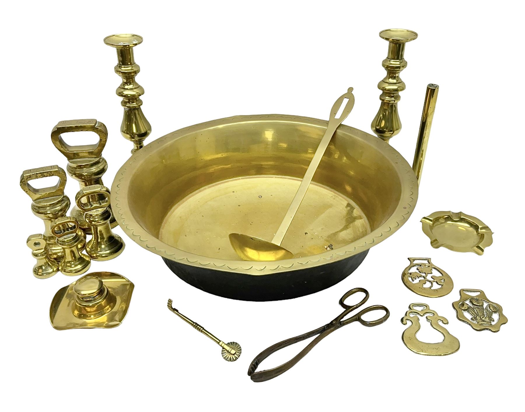 Collection of early 20th century and later brass, to include a large bowl with punched decoration to rim, pair of candlesticks, inkwell, weights, horse brasses, etc 