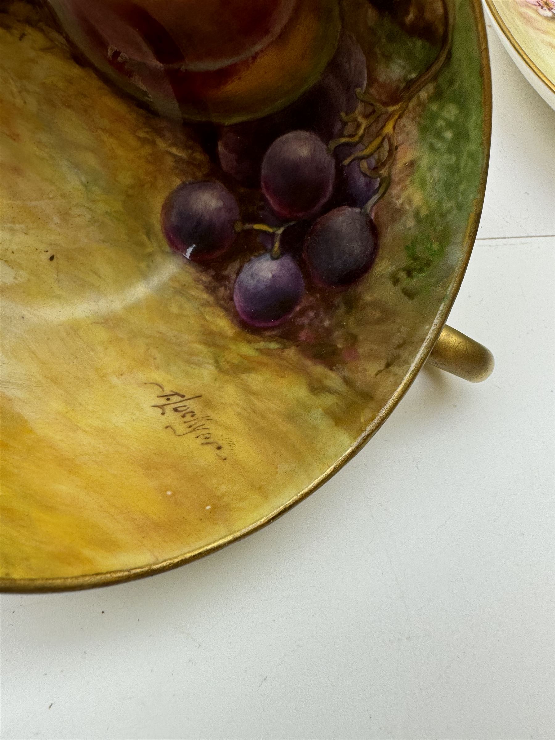 Early 20th century Royal Worcester cup and saucer decorated by Thomas Lockyer, the interior of the cup and the saucer decorated with fruit to a mossy background, with puce printed mark beneath 