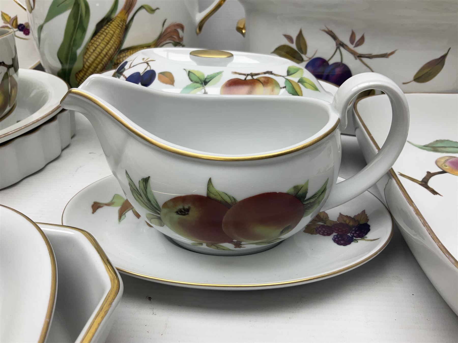 Royal Worcester Evesham pattern, including covered pot de cremes, twin handle tureen, serving dishes, flan dishes, side plates etc  