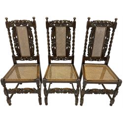 Set of seven (5+2) 19th century Carolean design oak dining chairs, scroll leaf and flower head carved cresting rail over spiral turned uprights and cane work back, the cane work seat on spiral turned supports united by plain stretchers, scrolled leaf carved middle rail 