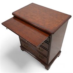 Small Georgian design walnut chest, rectangular moulded top with crossbanding and feather bands, shaped canted corners, slide over four graduating cock-beaded drawers, pierced brass handle plates, on bracket feet 