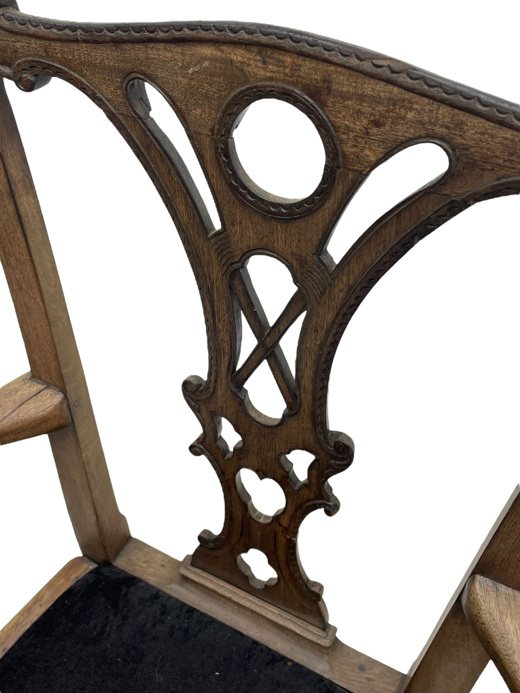 Unusual 18th century mahogany elbow chair, the shaped cresting rail with projecting shell carved ears, pierced and scroll carved splat over drop-in upholstered seat, shaped arms with ball and claw carved terminals, the seat rails carved with shell cartouches, on foliate carved cabriole supports with ball and claw feet 