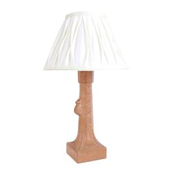 'Mouseman' tooled oak table lamp, tapered octagonal stem terminating to leaf carved square base, carved mouse signature, with pleated cream shade, by Robert Thompson of Kilburn