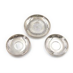 Three  silver pin dishes, comprising Victorian example with part fluted decoration and eng...