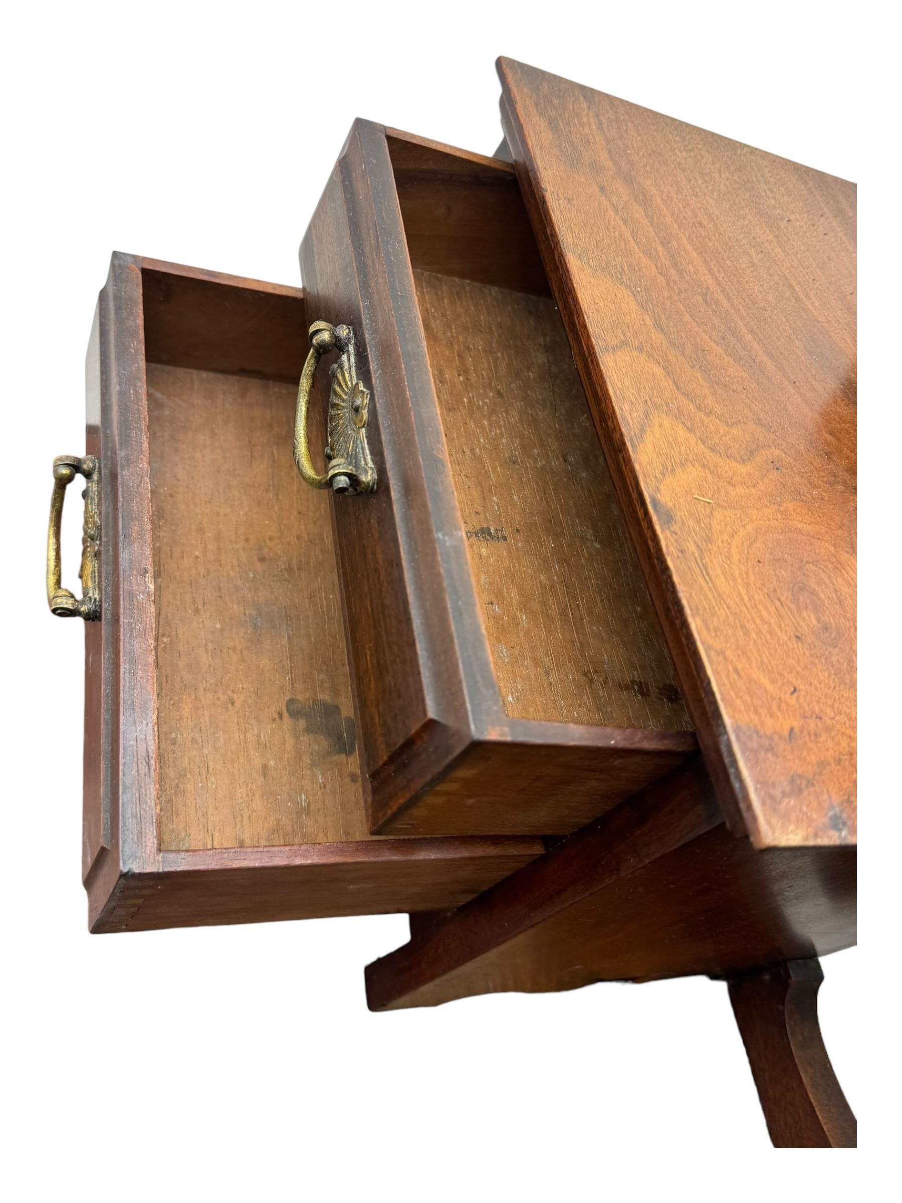 Late Victorian walnut dressing table, raised bevelled swing mirror over small trinket drawers, rectangular moulded top, fitted with two drawers, on turned supports united by undertier 