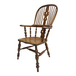 Elm and beech high back Windsor chair,  high hoop back with pierced splat and spindle supports over shaped saddle seat, raised on ring turned supports united by H-stretcher