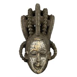Igbo Maiden Spirit mask, Nigeria, with painted face and a sculpted coiffure, H55cm 