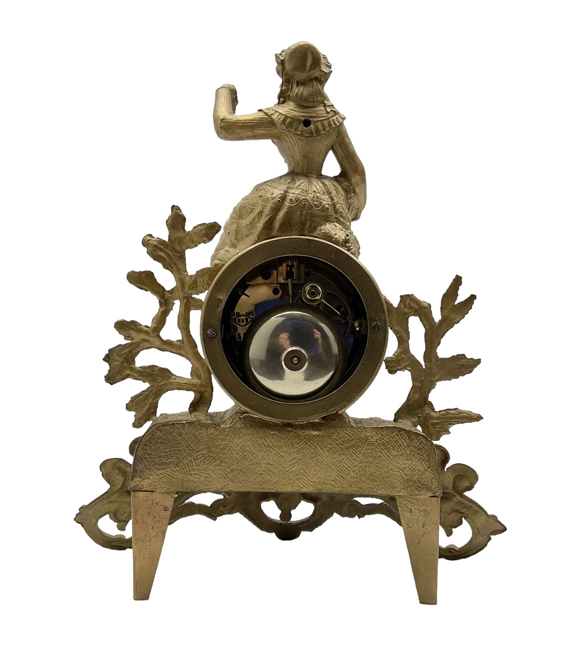 French - late 19th century 8-day mantle clock, in a spelter case with a solitary maiden seated above the drum movement, with an enamel dial, Roman numerals, minute markers and spade hands, twin train countwheel striking movement striking the hours and half hours on a bell. With pendulum and key. 