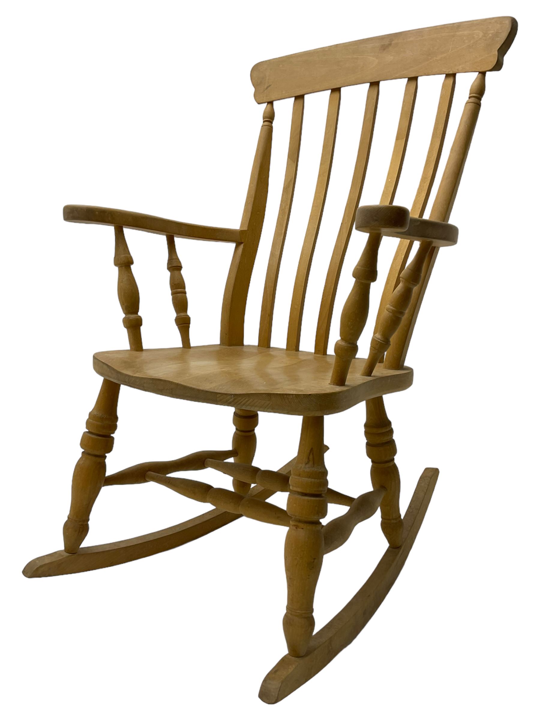 Farmhouse style beech rocking chair, shaped cresting rail on vertical slats, on turned front supports joined by swell-turned double H stretcher base