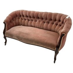 Late 19th century mahogany framed two-seat sofa, upholstered in buttoned pink fabric, on cabriole front supports, on castors 