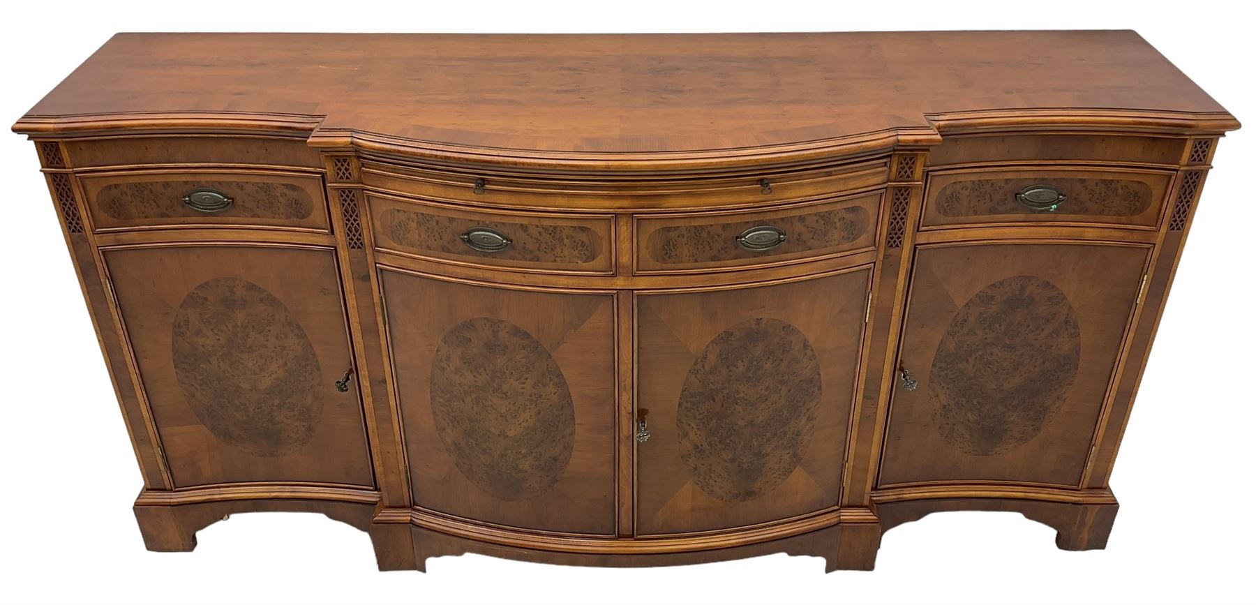 Wade - Georgian design yew wood bow-fronted sideboard, projecting moulded top over four cockbeaded frieze drawers, the central two with pull-out slides, four cupboards below with figured veneers, raised on bracket feet