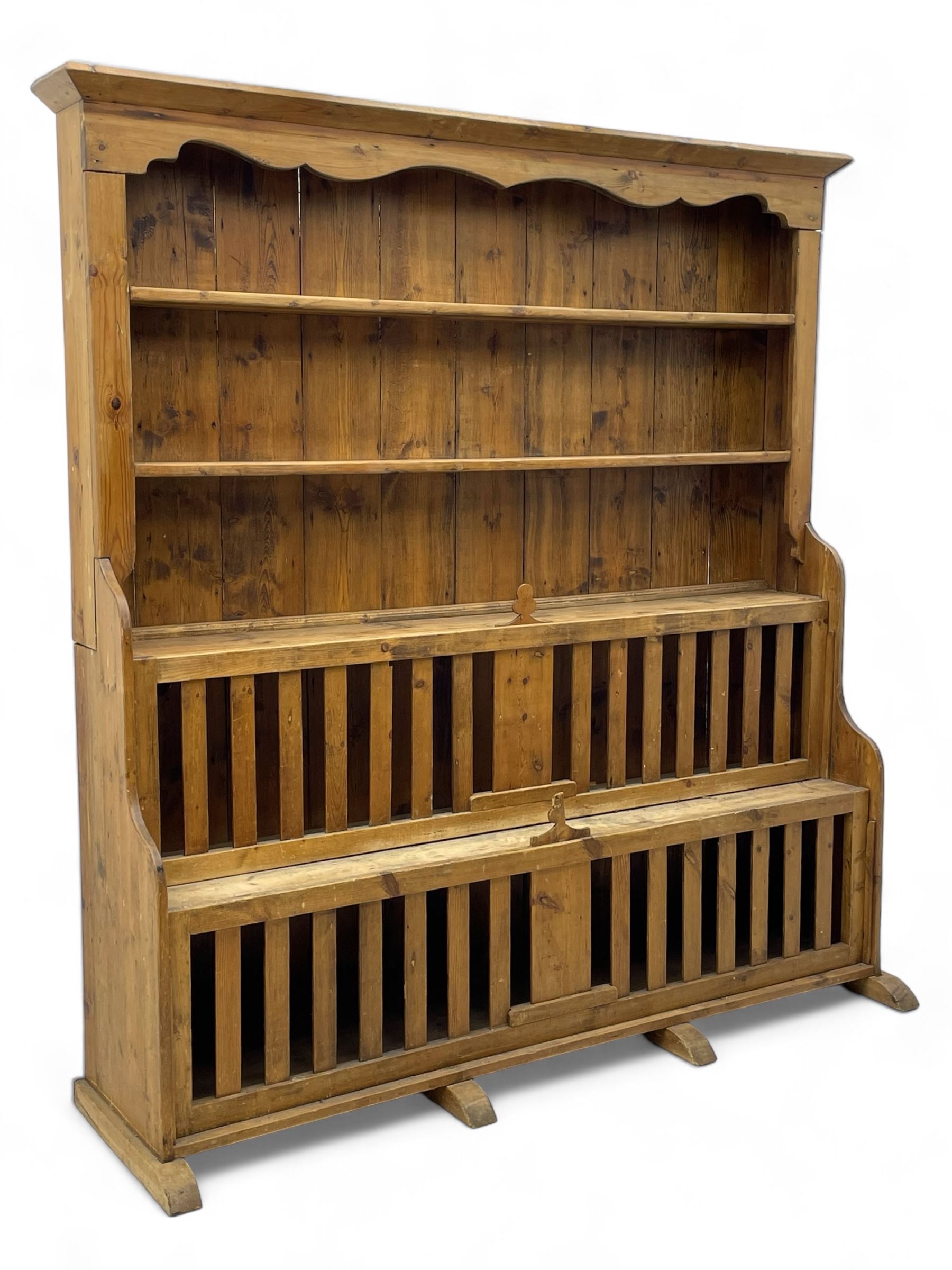 Waxed pine 'chicken coop' or 'hutch' dresser, projecting cornice over shaped frieze and three tier plate rack, the stepped waterfall lower section fitted with two slatted chicken coops, on sledge feet 