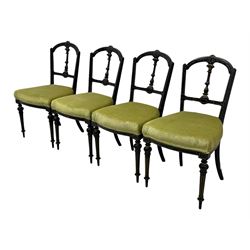 Set of four late Victorian ebonised dining chairs, decorated with carved and gilt foliate decoration, upholstered seats, on turned and fluted front supports 