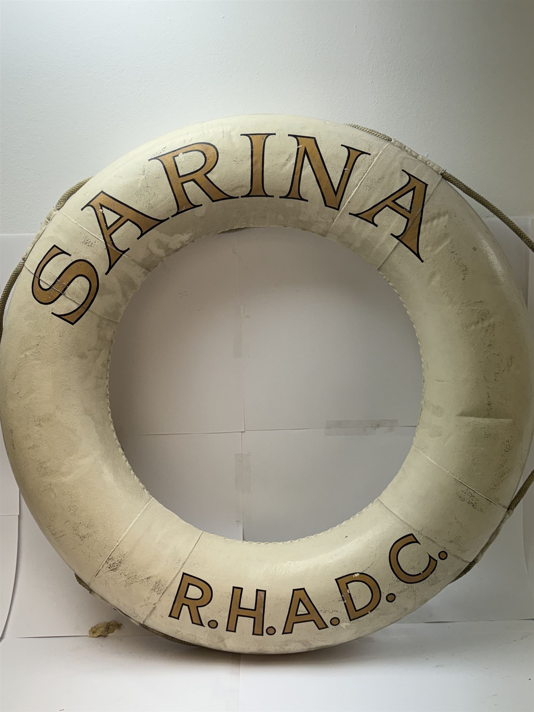 Four mid 20th century yacht lifebuoys, each painted in gold and black lettering 'Sarina R.H.A.D.C', upon a white ground, D68cm