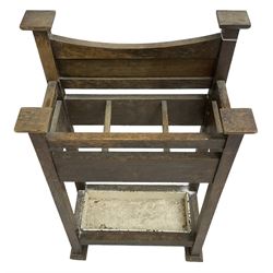 Early 20th century Arts & Crafts oak stick stand, panelled back over three divisions, fitted with metal drip tray, on square supports